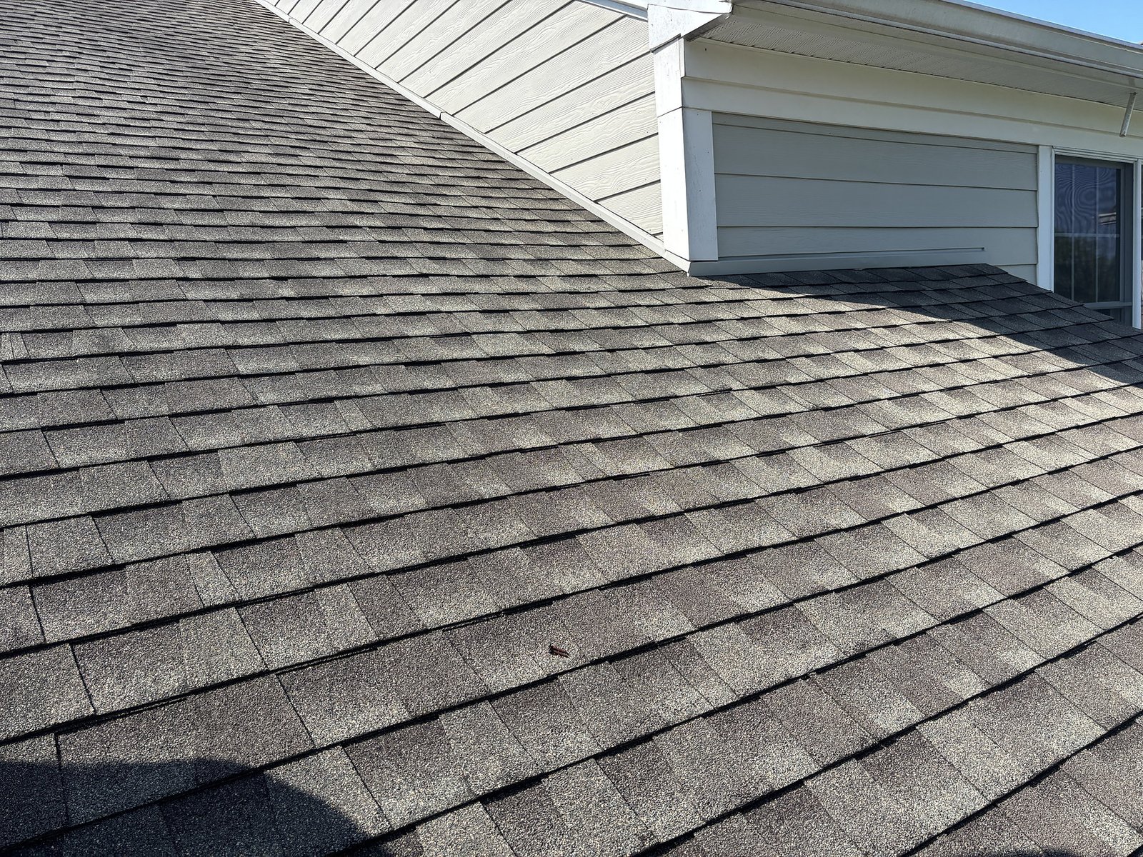 Asphalt shingle roofing detail on a residential home